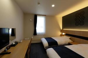 Hotel REUS Ashoro的电视和/或娱乐中心