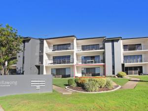 an apartment building with a sign in front of it at Illawong 2 in Mooloolaba