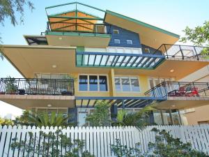 a building with balconies and a white fence at Little Hill 3 River Side 2 Bedroom Apartment across the road to the beach in Mooloolaba