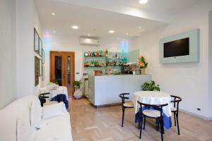 a living room with two tables and a bar at Grappolo D'Oro in Pietrasanta