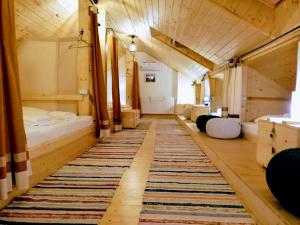 a train room with a rug on the floor at Zozo Hostel in Braşov