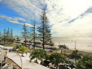 a view of a beach with palm trees and the ocean at Zanzibar 404, Sensational 2 Bedroom Oceanview Apartment in Mooloolaba