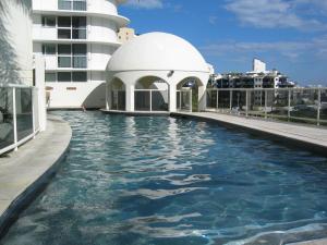 a pool on the side of a building at Zanzibar 404, Sensational 2 Bedroom Oceanview Apartment in Mooloolaba