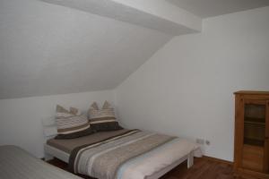 a bedroom with a bed with pillows on it at Bergbaude Albrechts in Albrechts