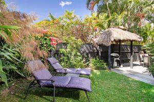 two chairs and a gazebo in a yard at The Islander Apartment 1, Noosa Heads in Noosa Heads