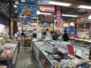 a grocery store with people standing around a counter at THE HOTELS HAKATA KASANE Bayside in Fukuoka