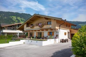 a large house with a patio in front of it at Landhaus Ambiente in Westendorf