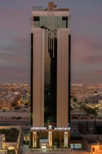 a large building with two towers in a city at Crown Rose AlSahafa Hotel in Riyadh