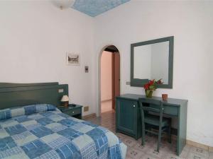 Postel nebo postele na pokoji v ubytování Hotel La Ninfea