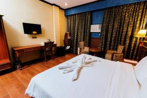 a hotel room with a bed and a desk at Hotel San Marco in General Santos