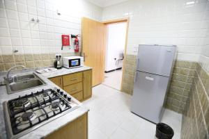 Kuchyň nebo kuchyňský kout v ubytování Al Rayyan Hotel Apartments Muscat + 27 fotografií