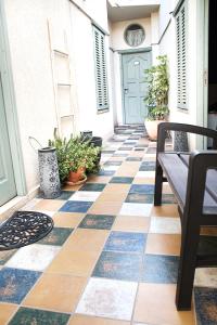a patio with a checkered floor and a blue door at Al-Hakim Boutique Hotel Old Town Nazareth in Nazareth