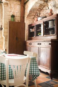 a kitchen with a table and a wooden cabinet at Al-Hakim Boutique Hotel Old Town Nazareth in Nazareth