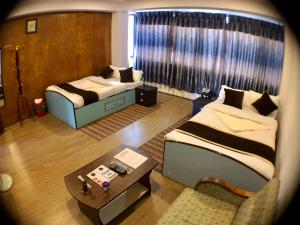 Postel nebo postele na pokoji v ubytování Hotel Satyam