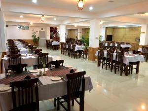a dining room with tables and chairs in a restaurant at Hotel Satyam in Banepa