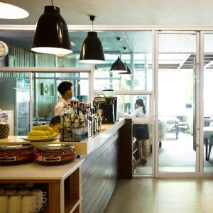 a woman standing in a kitchen with a counter at Baboona Beachfront Living in Pattaya Central