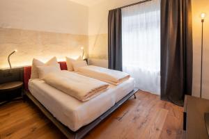 Postelja oz. postelje v sobi nastanitve Flurin Suites