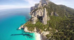 an aerial view of a mountain with a beach at Hotel Bia Maore in Baunei