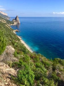 a view of the ocean from a hill at Hotel Bia Maore in Baunei