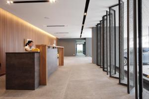 a woman standing at a counter in an office lobby at Maleesa Place Hua Hin in Hua Hin +22 photos