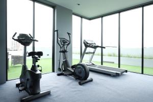 a gym with two treadmills and two exercise bikes at Maleesa Place Hua Hin in Hua Hin