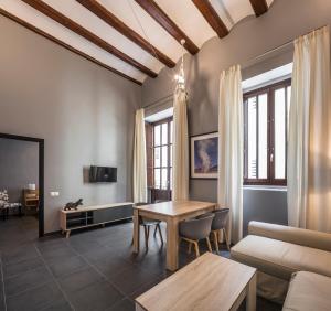 a living room filled with furniture and a large window at Mon Suites San Nicolas in Valencia