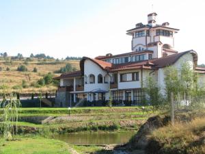 un grande edificio su una collina accanto a un fiume di Park Hotel Eagle Stone a Koprivshtitsa