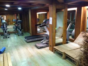 a gym with a treadmill and two chairs in a room at La Ginabelle Chamonix in Chamonix-Mont-Blanc