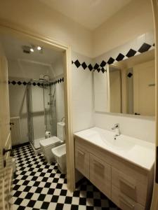 a bathroom with a sink and a toilet and a mirror at Rialto Mercato apartment suite in Venice