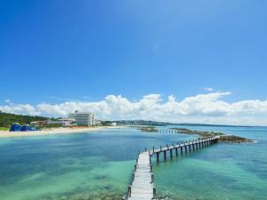a dock in the water next to a beach at Sheraton Okinawa Sunmarina Resort in Onna