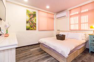 Voodi või voodid majutusasutuse Meizhou Hot Spring Hotel溫泉商旅 toas