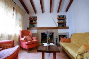 a living room with two couches and a fireplace at La Casa del Paseo in Baños de la Encina