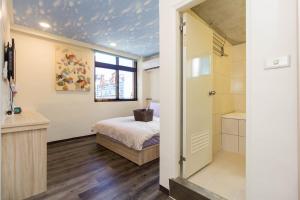 Voodi või voodid majutusasutuse Meizhou Hot Spring Hotel溫泉商旅 toas