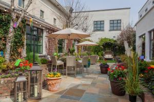 an outdoor patio with tables and chairs and flowers at Glenroyal Hotel in Maynooth