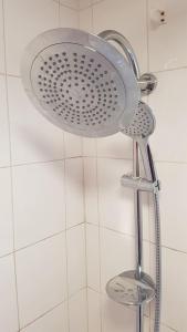 a shower with a shower head in a bathroom at Stylish and homely space with considered work area in Norwich