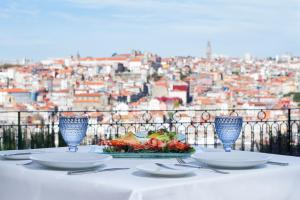 a table with a plate of food and two glasses at The Yeatman in Vila Nova de Gaia