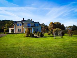 a house with a soccer ball in the yard at Willa Kamieniec Bieszczady in Polańczyk