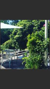 a group of picnic tables and benches in a park at Ty Mawr Hotel in Llanbedr