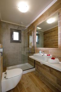 a bathroom with a toilet and a sink and a shower at Apartment Tilio - New apartment with private pool 1400m from the beach in Rethymno Town