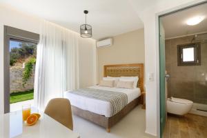 a bedroom with a bed and a bathroom with a tub at Apartment Tilio - New apartment with private pool 1400m from the beach in Rethymno