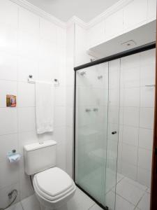 a bathroom with a toilet and a glass shower at Polo Hotel in São José dos Campos