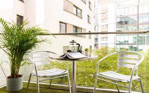 two chairs and a table on a balcony at Fabulous 3 Bed 2 Bath near Victoria Station in London