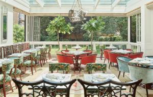 a dining room with tables and chairs on a patio at The Goring in London