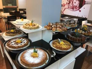a bunch of cakes and pastries on a counter at Idea Hotel Milano Malpensa Airport in Case Nuove