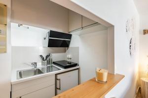 a small kitchen with a counter and a sink at Studio centre ville avec parking in Sanary-sur-Mer