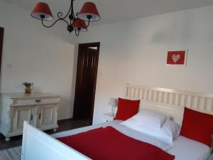 A bed or beds in a room at Kálium Vendégház