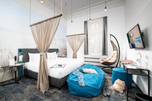 a bedroom with a bed and a chair at Three Corners Hotel Anna in Budapest +71 photos