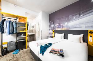 a bedroom with a white bed and a black and yellow wall at Three Corners Hotel Anna in Budapest