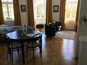 a living room with a dining room table and chairs at Apartment Vienna Smart Living in Vienna