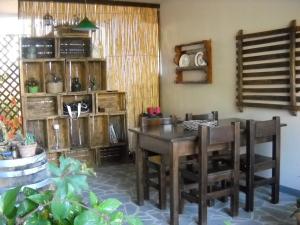 a dining room with a wooden table and chairs at La Balia in Marrùbiu